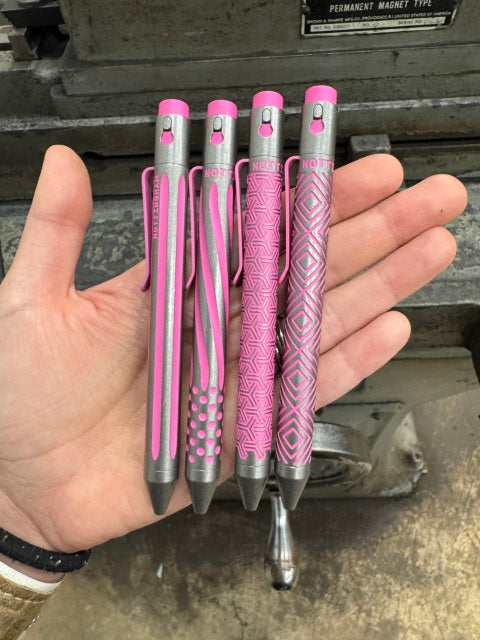 Titanium Custom Cerakote Pens held in hand showing size - custom engraved tactical pens NTI